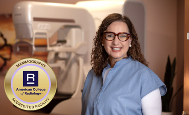 Mammography Technologist, Deborah Culbertson stands in front of a Fuji 3D Mammography machine, installed December 2024.Picture of mammography technologist standing next to Fuji 3D Mammography machine, overlayed with seal of American College of Radiology for Mammography Accreditation.